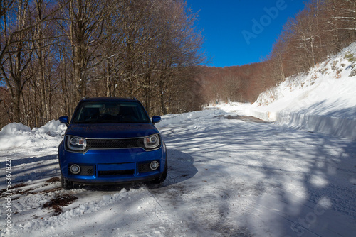 blue car on the snow