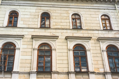 Facade of an ancient building with old windows