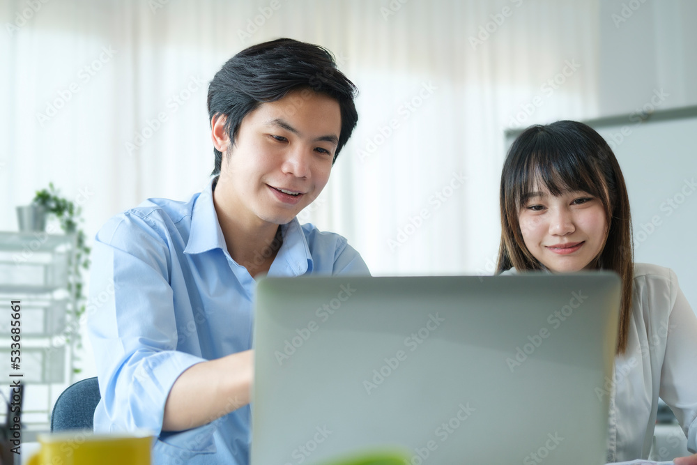 Two young business colleague discussing online information, working together in corporate office. Two young business colleague discussing online information, working together in corporate office.