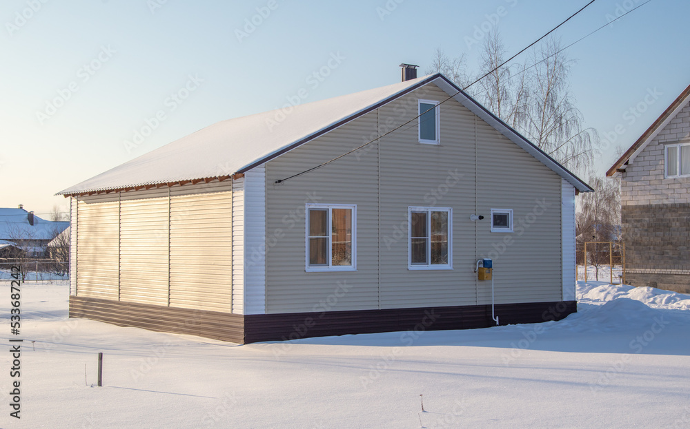 One-story house covered with snow. One-story house covered with snow.