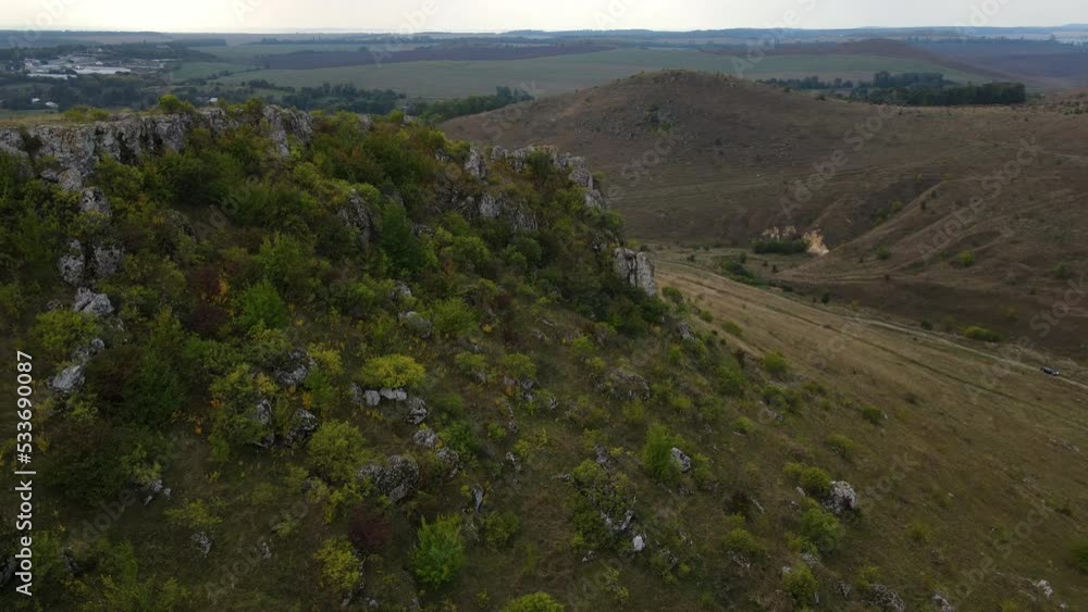 Aerial view on the rocky hill, drone flies forwards over stony landscape Aerial view on the rocky hill, drone flies forwards over stony landscape