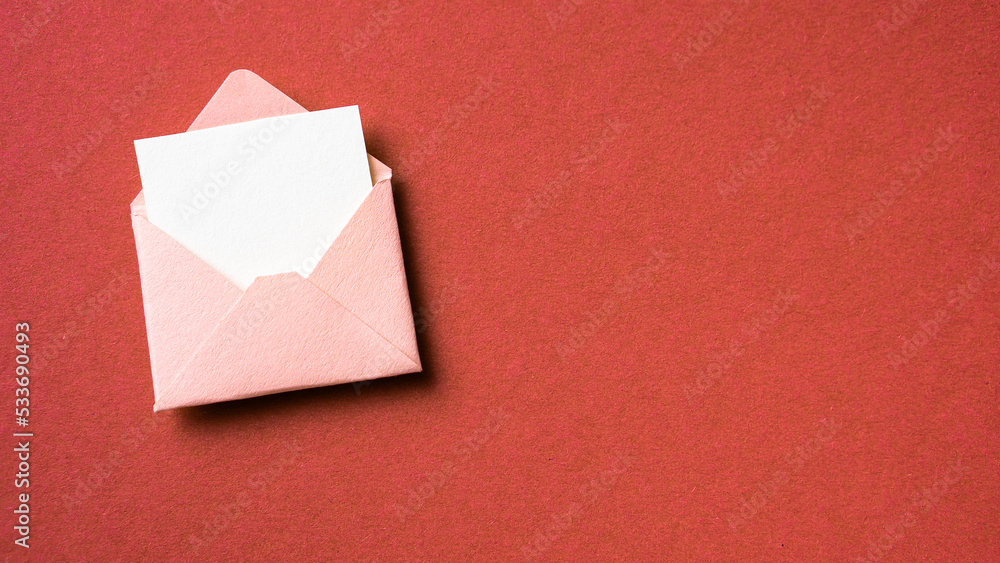 Fototapeta premium Blank white card with pink paper envelope template mockup