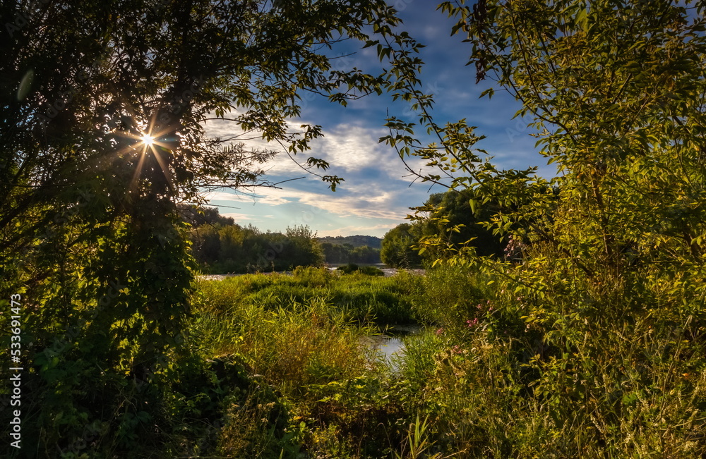 Summer landscape with hill, trees, grass, river and blue sky with white clouds Summer landscape with hill, trees, grass, river and blue sky with white clouds