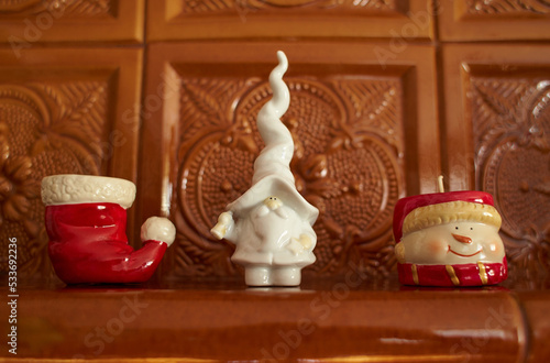 Close up of white Ceramic Santa, Chistmas candle and snowman. © Irene Fox