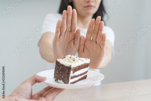 Canvas-taulu eat less sugar for health, women avoid to eat chocolate cake and sweets during s