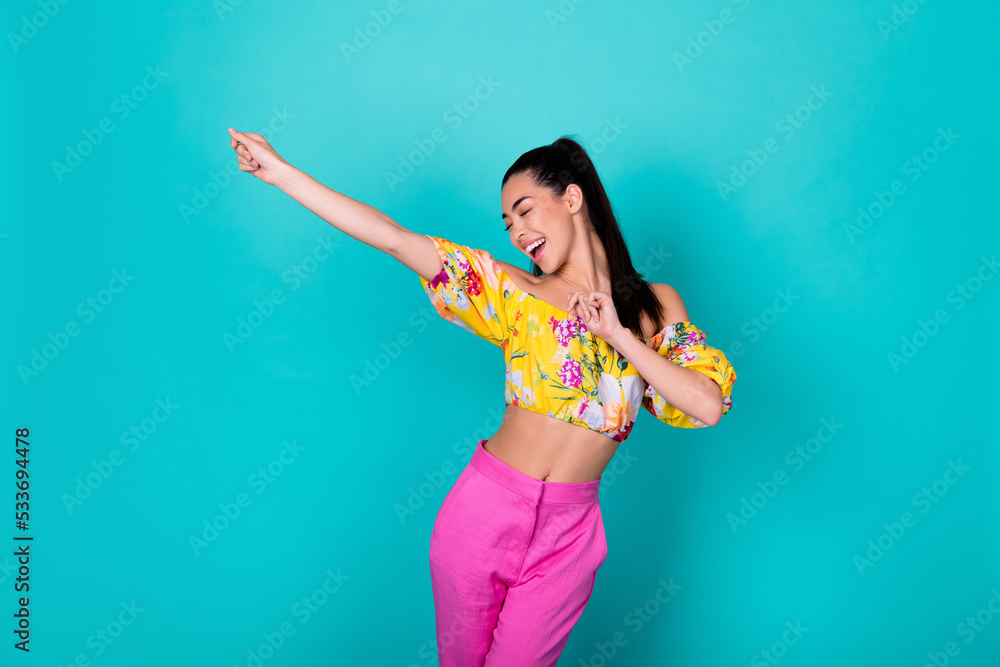 Photo of hooray tail hairdo lady dance wear printed top pink pants isolated on turquoise color background Photo of hooray tail hairdo lady dance wear printed top pink pants isolated on turquoise color background