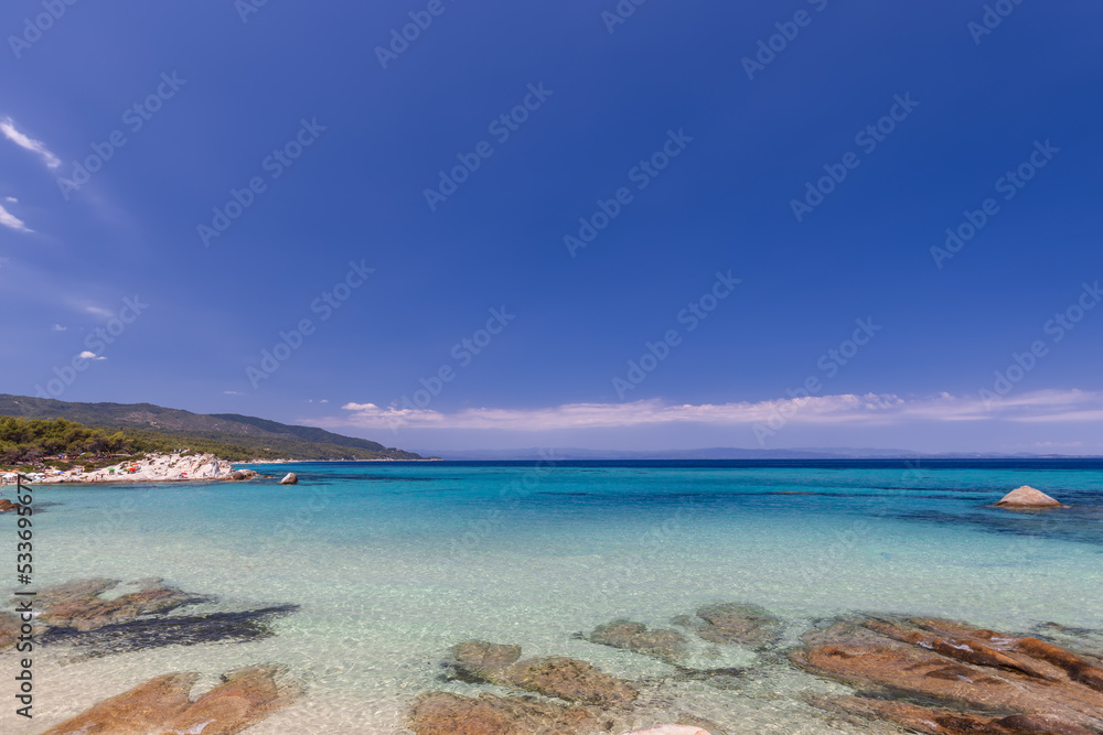 Fototapeta premium Portokali (also known as Orange or Kavourotrypes beach) has shallow lagoon which stretches into the sea for 30 m from the coastline. Sithonia, Halkidiki, Greece
