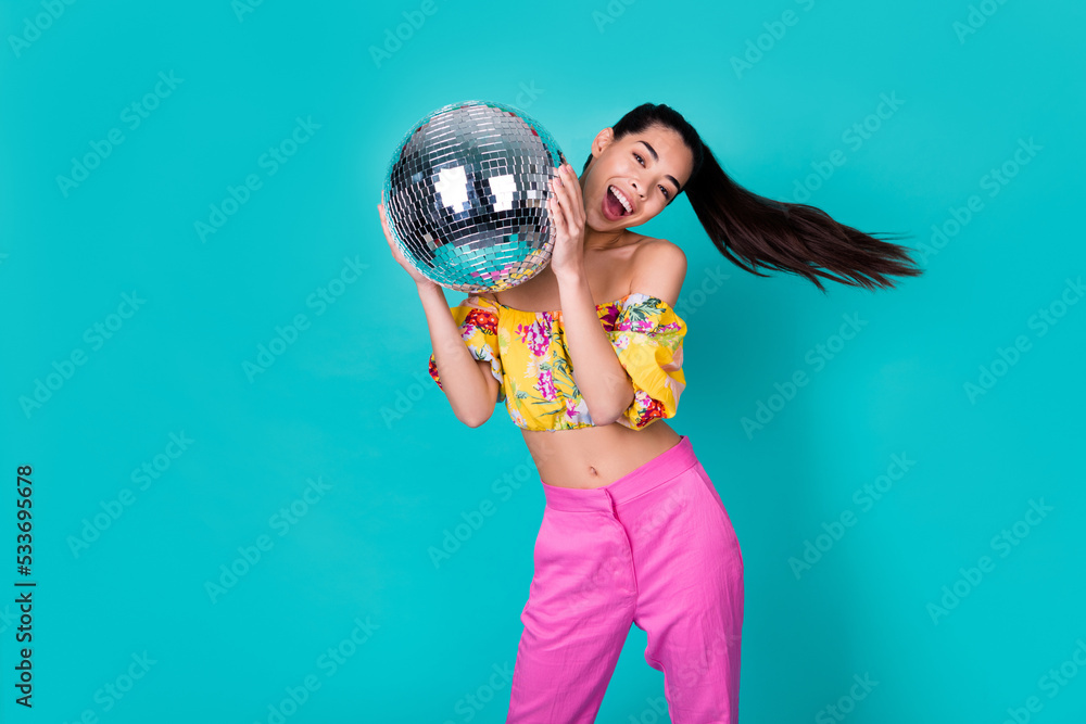 Naklejka premium Photo of hooray millennial lady hold disco ball wear top pants isolated on teal background
