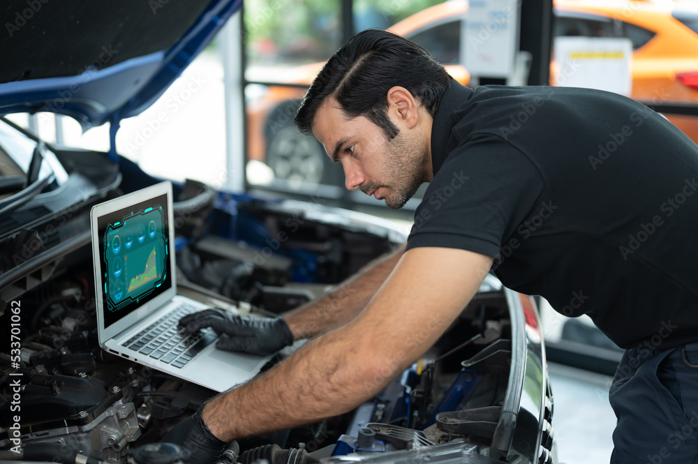 Mechanic Asian man close up using laptop computer and diagnostic software to tuning fixing repairing car engine automobile vehicle parts using tools equipment in workshop garage support service Mechanic Asian man close up using laptop computer and diagnostic software to tuning fixing repairing car engine automobile vehicle parts using tools equipment in workshop garage support service