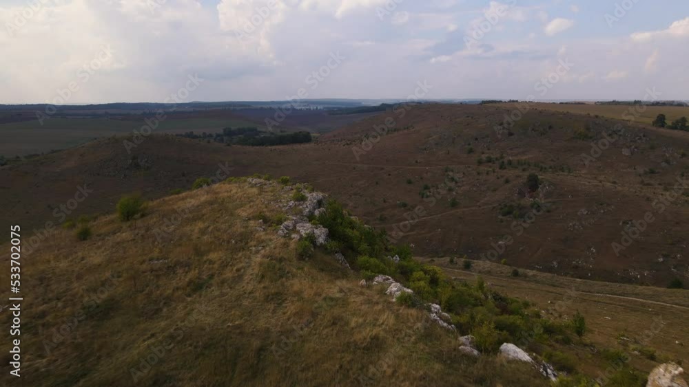 Aerial view on rocky hill, drone flies fast forwards over stony landscape Aerial view on rocky hill, drone flies fast forwards over stony landscape