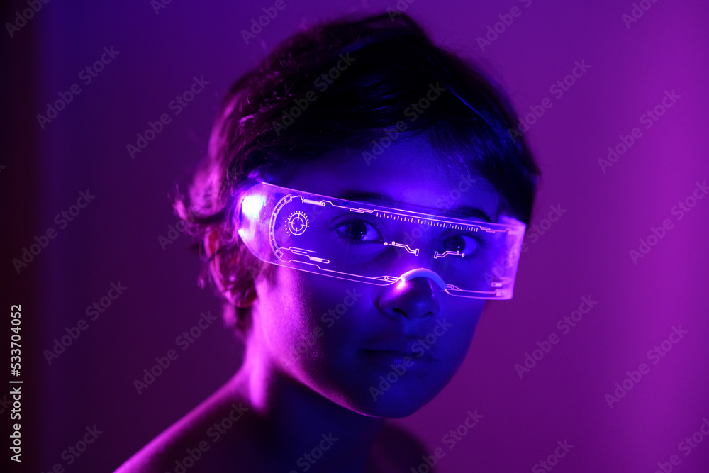 Girl wearing futuristic glasses against purple background Girl wearing futuristic glasses against purple background