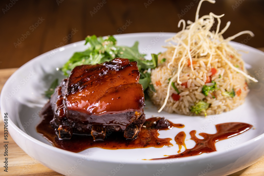 Typical peruvian food and drinks, pork belly with rice and vegetables Typical peruvian food and drinks, pork belly with rice and vegetables