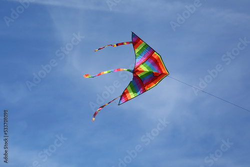 Kite with rainbow colors flying in the sky symbol of hope joy brotherhood photo