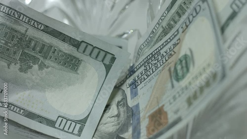 100 Dollar Bills Fall, Drop Into Crystal Bowl Close Up photo