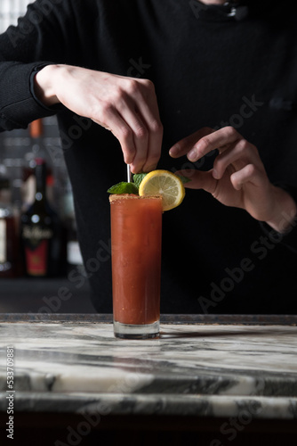 Bartender garnishing a cocktail