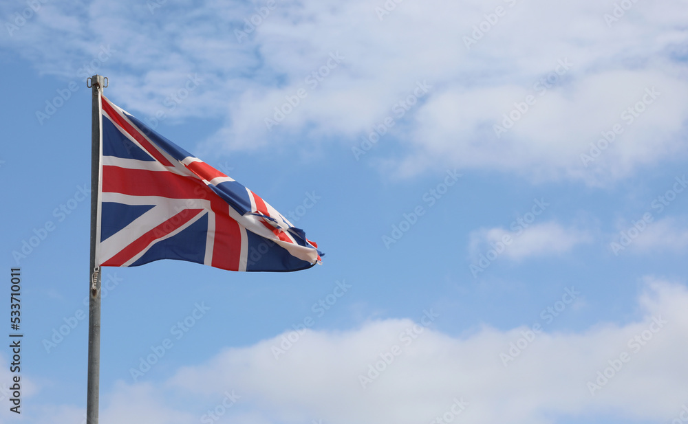 united kingdom flag on the blue sky and white clouds