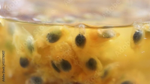 Closeup of natural passion fruit juice with seeds.