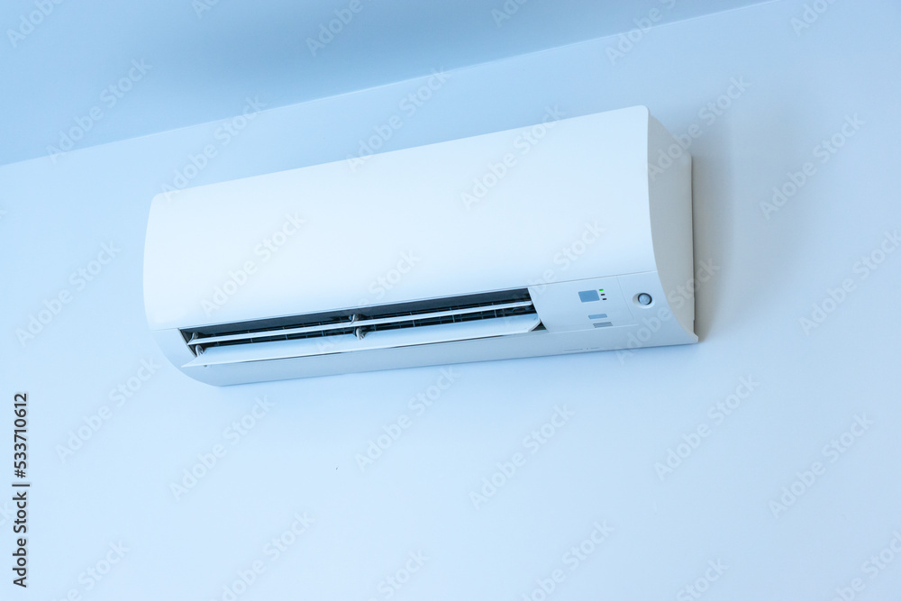 White wall with hanging air conditioning unit and copy space White wall with hanging air conditioning unit and copy space
