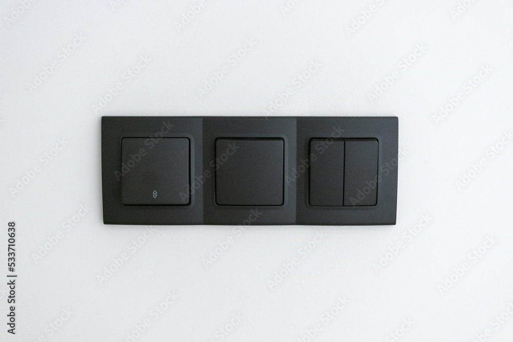 White wall with several switches to turn the black light on and off White wall with several switches to turn the black light on and off