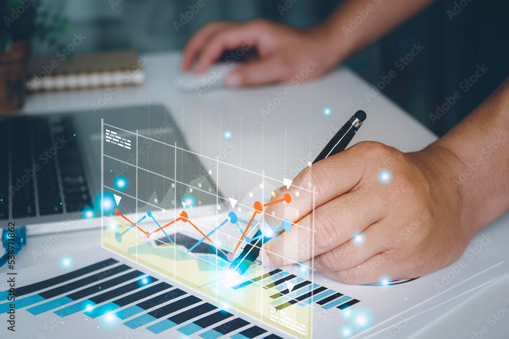 Businessman analyzing trading graph financial data.Business finance background.stock Market Investments Funds and Digital Assets Businessman analyzing trading graph financial data.Business finance background.stock Market Investments Funds and Digital Assets