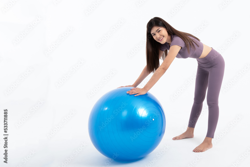 Portrait images of Asian attractive woman smile and wearing gym clothes Holding a blue exercise ball, On white background, to Exercise for health and weight loss concept. Portrait images of Asian attractive woman smile and wearing gym clothes Holding a blue exercise ball, On white background, to Exercise for health and weight loss concept.