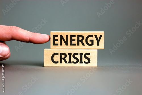 Global energy crisis symbol. Concept words Energy crisis on wooden blocks. Beautiful grey table grey background. Businessman hand. Business global energy crisis concept. Copy space.