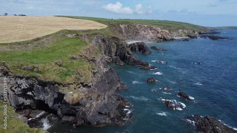Farm fields on the coast. Landscape of the West Cork. Picturesque rocks on a sunny day, the nature of Ireland. The area near Clonakilty. Farm fields on the coast. Landscape of the West Cork. Picturesque rocks on a sunny day, the nature of Ireland. The area near Clonakilty.