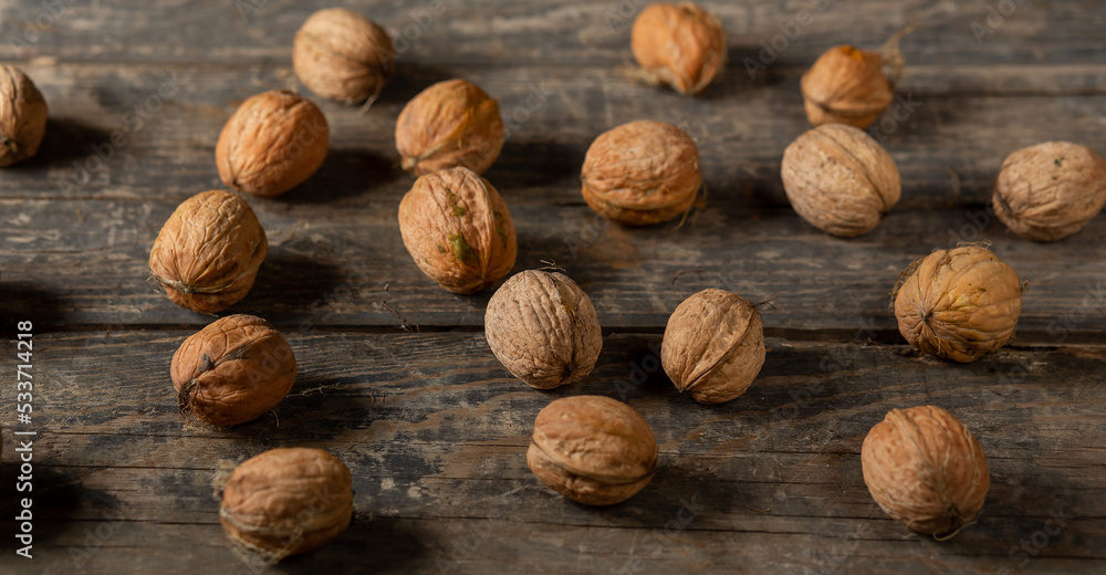 Heap of walnuts on wooden boards Heap of walnuts on wooden boards