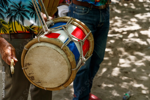 Dominican Republic. The musician plays the drum. Drummer. A group of beach musicians. Merengue music.