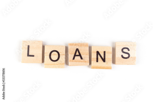 Loans- word composed fromwooden blocks letters on White background, copy space for ad text.