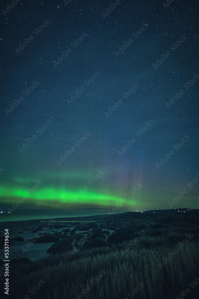Coastline of Denmark at night with northern lights. High quality photo