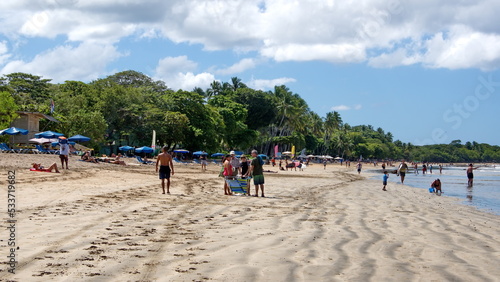 Tourists on the beach in Tamarindo, Costa Rica photo
