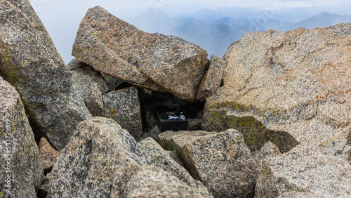 Rocks at and check in box at the summit of Mount Harvard