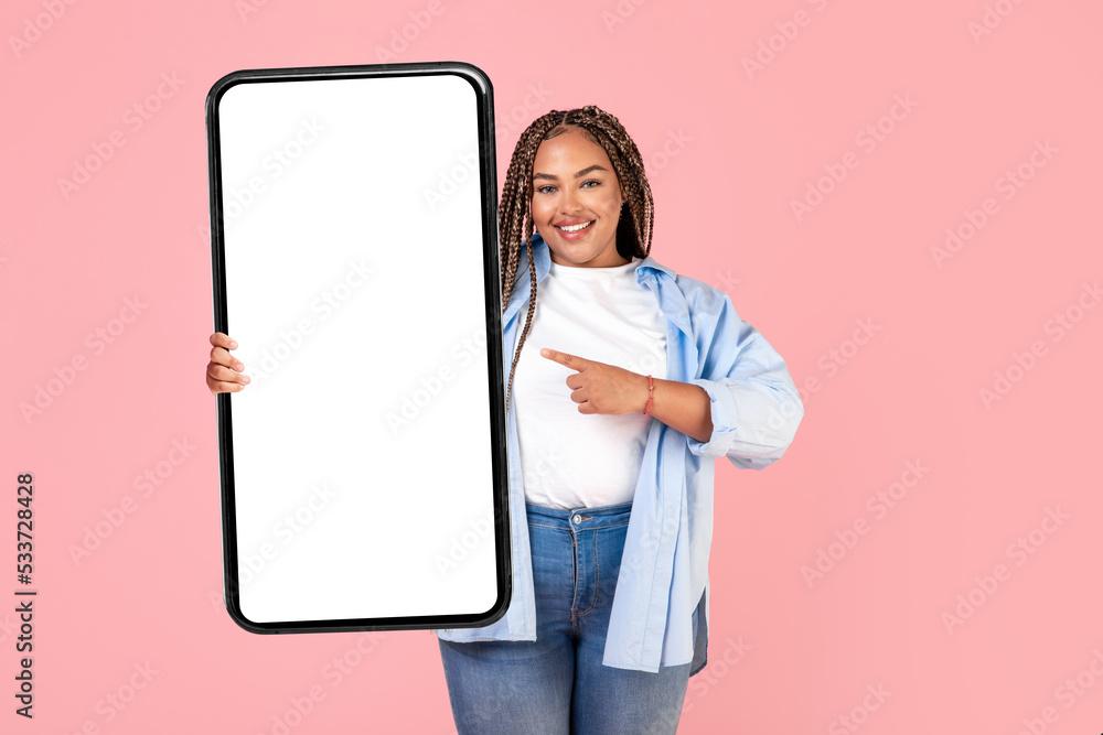 Happy African American Lady Holding Large Cellphone Over Pink Background Happy African American Lady Holding Large Cellphone Over Pink Background