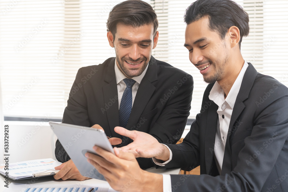Business people meeting. Businessman, partnership planning strategy of project, brainstorming with colleague, using device on tablet, computer analyzing data, discussing document, paperwork at office. Business people meeting. Businessman, partnership planning strategy of project, brainstorming with colleague, using device on tablet, computer analyzing data, discussing document, paperwork at office.