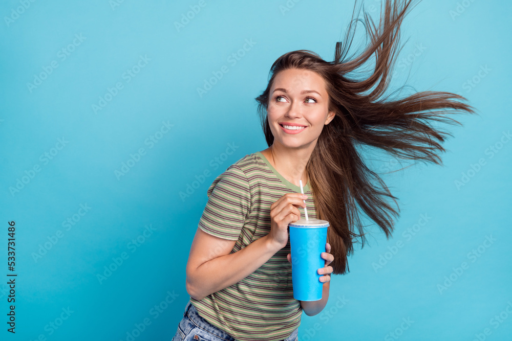 Photo of cheerful tender lady beaming shiny smile stylish striped clothes interested look empty space ad isolated on blue background Photo of cheerful tender lady beaming shiny smile stylish striped clothes interested look empty space ad isolated on blue background