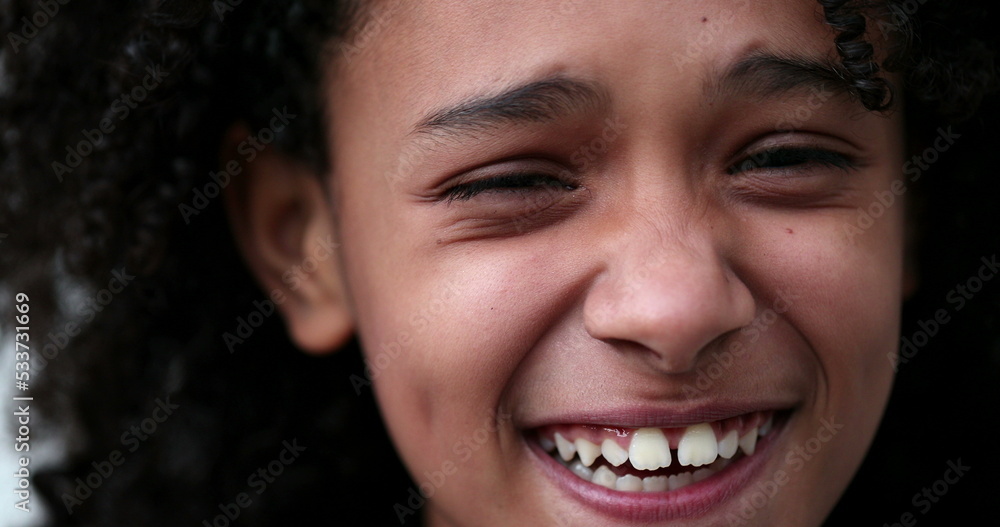 Portrait little girl smiling and laughing. African descent child face close-up Portrait little girl smiling and laughing. African descent child face close-up