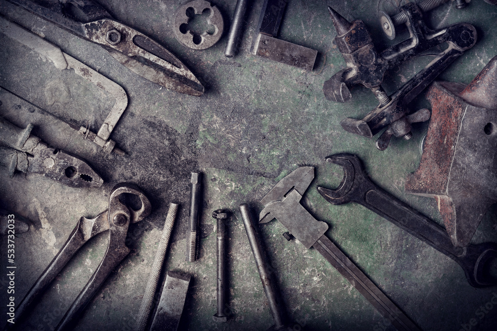 grungy old metalwork tools on stained table background (processing cross-process) grungy old metalwork tools on stained table background (processing cross-process)