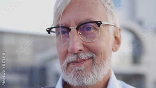 Mature man sale manager looking at camera and smiling, introducing his goods