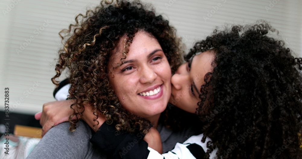 Mother and daughter spontaneous love and hug. Child and parent portrait Mother and daughter spontaneous love and hug. Child and parent portrait