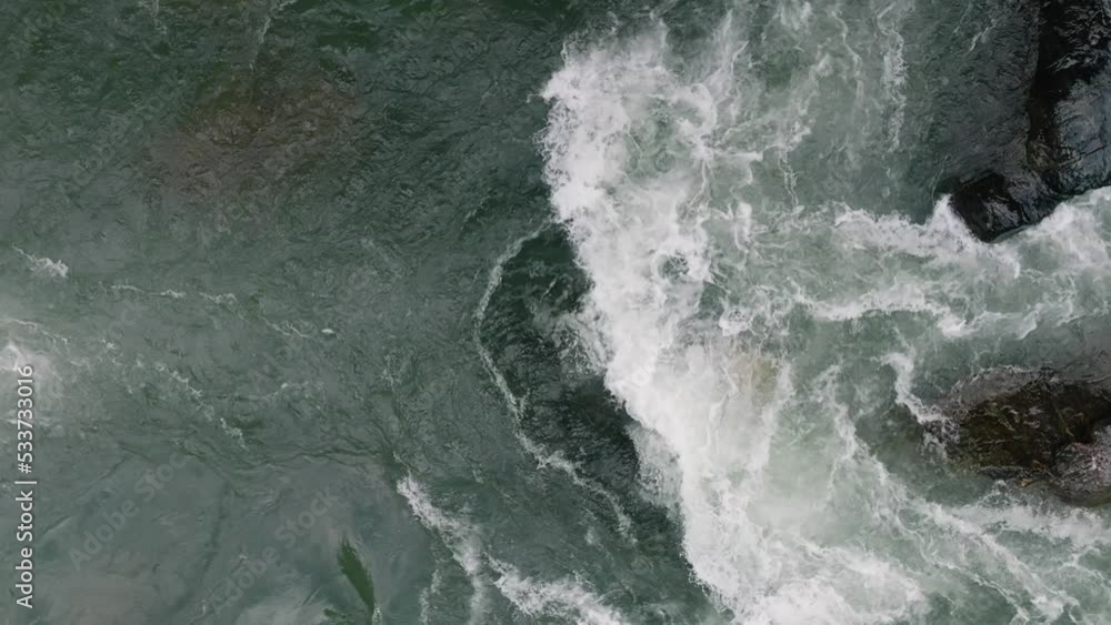 Mountain river. A rapid flow of clean water. Bubbling water, foam and splashes. Water flow in a mountain gorge, view of the water from a aerial view. Slow motion video 120 fps Mountain river. A rapid flow of clean water. Bubbling water, foam and splashes. Water flow in a mountain gorge, view of the water from a aerial view. Slow motion video 120 fps