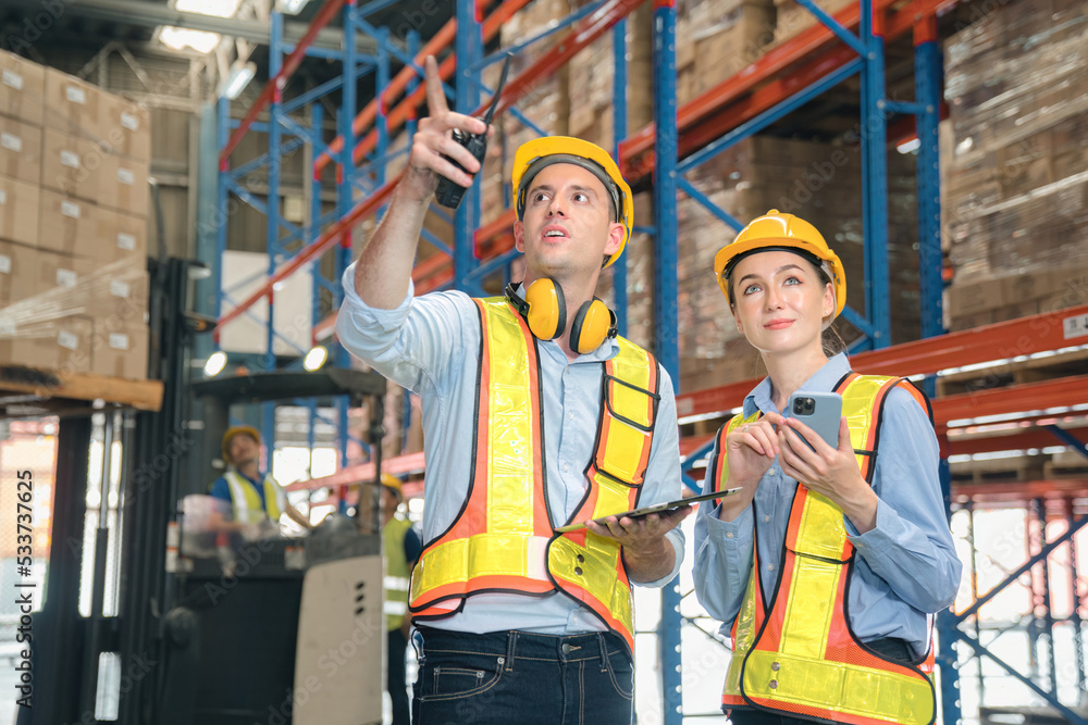 Caucasian man, woman warehouse supervisor discuss and use tablet check package with forklift driver worker load box on shelf, product distribution inventory management,Logistics shipping business plan