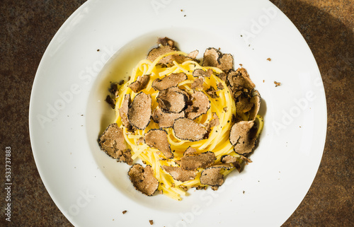 Pasta with fresh truffle mushroom background.Restaurant menu plate background. photo