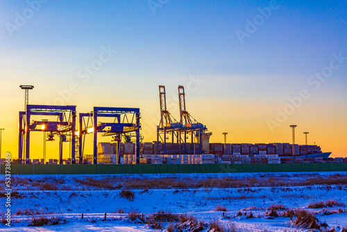 Shipyard cranes shipyard crane sunset winter container port Bremerhaven Germany. photo