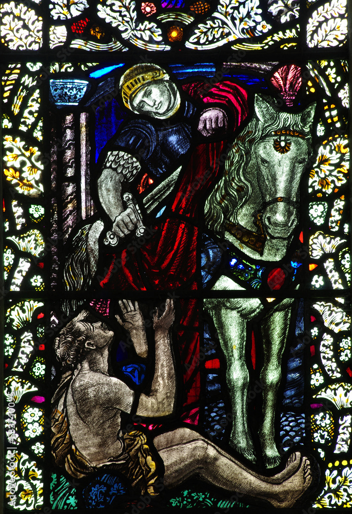Obraz premium Saint Martin cuts (shares) his coat for a poor person (stained glass window)