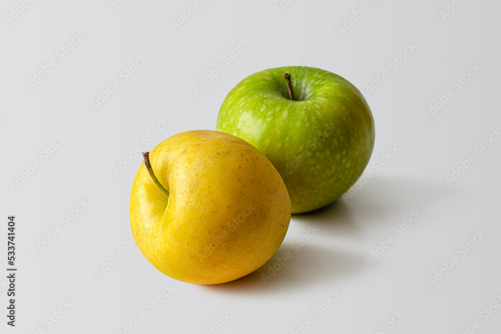 Yellow and green apple on a light background Yellow and green apple on a light background