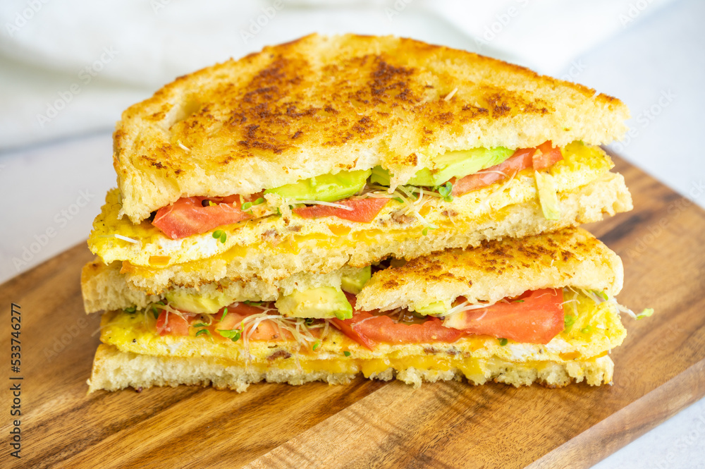 Grilled Omelette Sandwich with Avocado, Tomato, and Sprouts