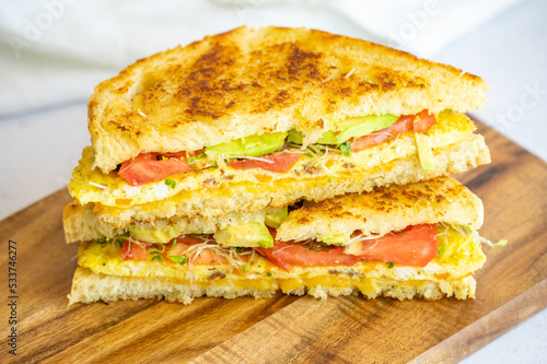 Grilled Omelette Sandwich with Avocado, Tomato, and Sprouts
