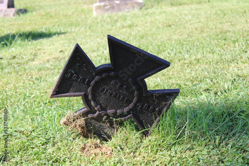 Tombstone In A Cemetery During The Day. 