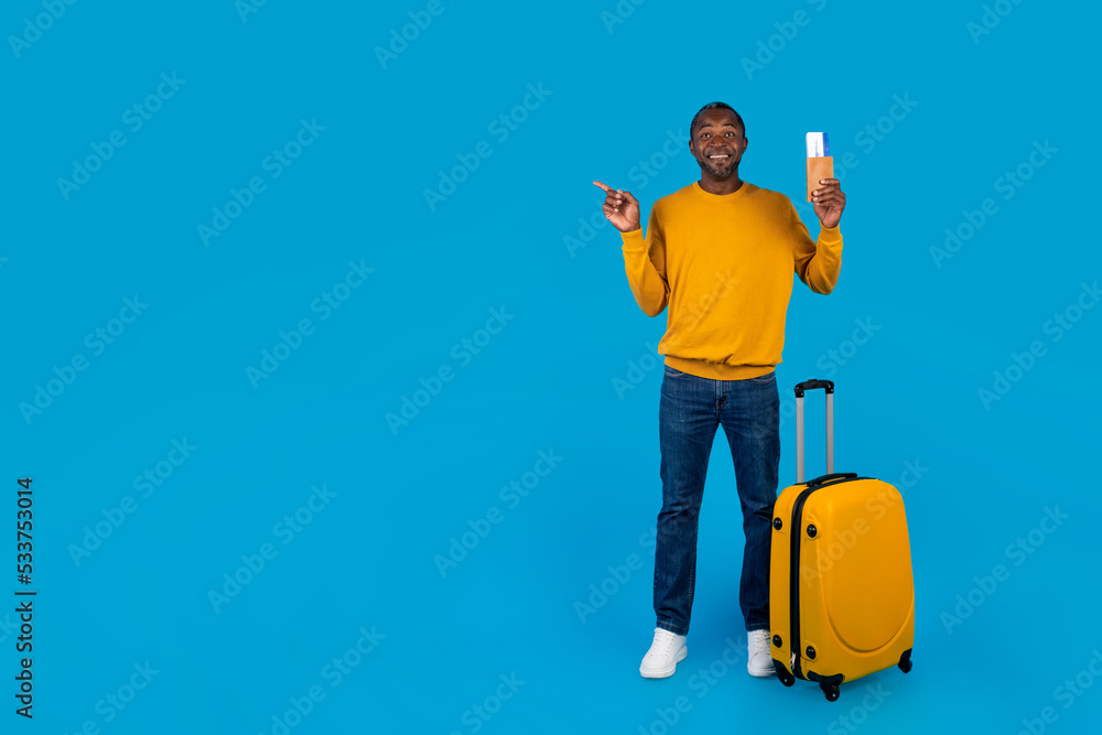 Happy black man having journey, pointing at copy space Happy black man having journey, pointing at copy space